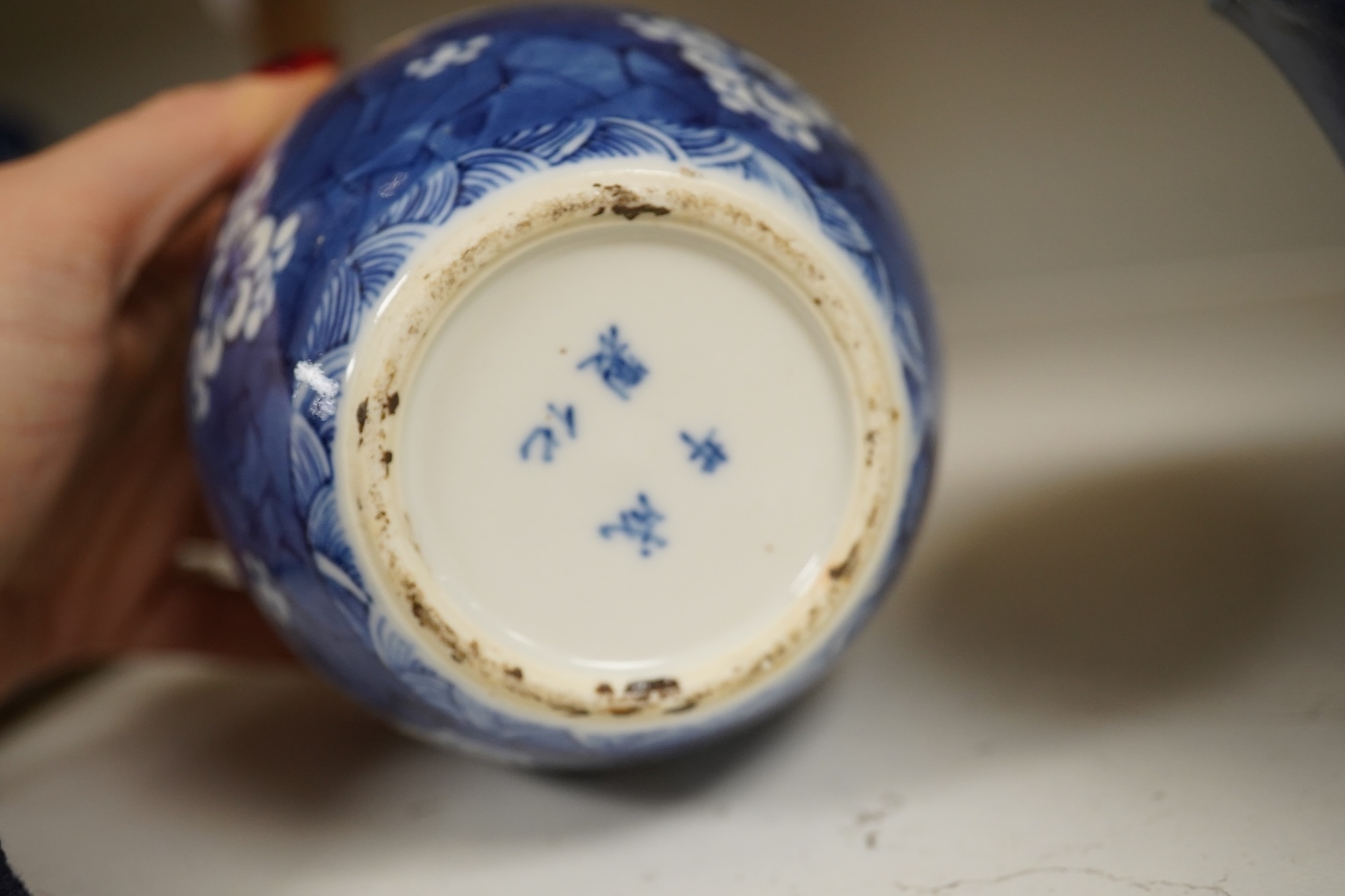 A Chinese powder blue bowl, early 18th century and a Chinese blue and white prunus jar - tallest 13cm. Condition - fair